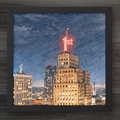 Framed artwork of a Saint Pauls First National Bank with a prominent building featuring a red '1st' sign against a blue sky.