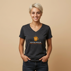 A smiling blonde woman wearing a dark heather gray v-neck t-shirt with a coffee cup graphic and the text 'HOCUS POCUS I NEED COFFEE TO FOCUS' on the front, posed against a solid beige background.
