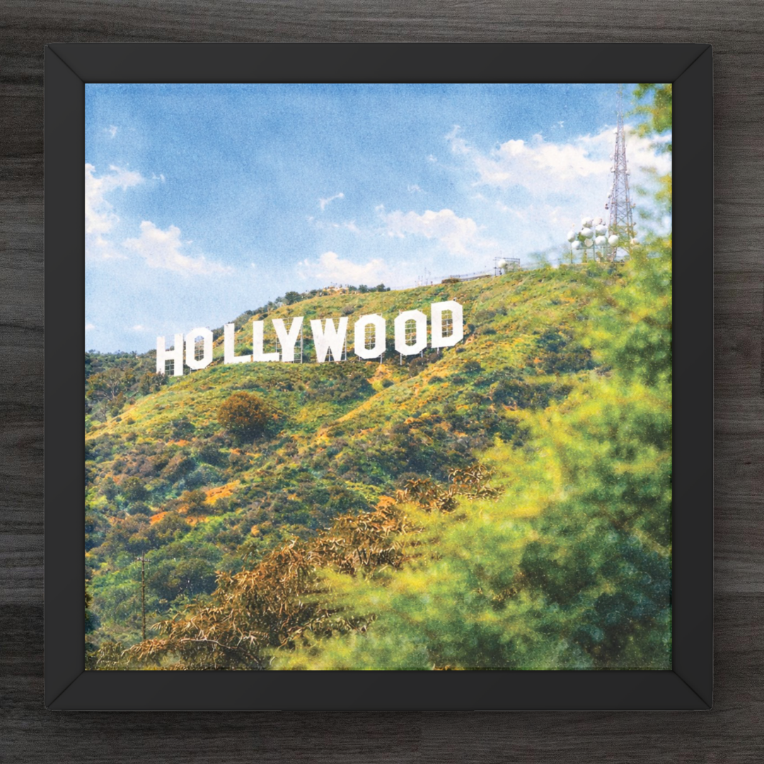 Framed picture of the Hollywood sign on a hillside with a clear sky.