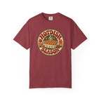 A red t-shirt with a circular retro-style graphic that reads 'HOTDISH SEASON' around an illustration of a hot casserole dish, photographed on a clean white background.