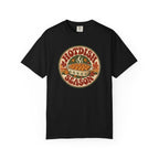 A black t-shirt with a circular retro-style graphic that reads 'HOTDISH SEASON' around an illustration of a hot casserole dish, photographed on a clean white background.