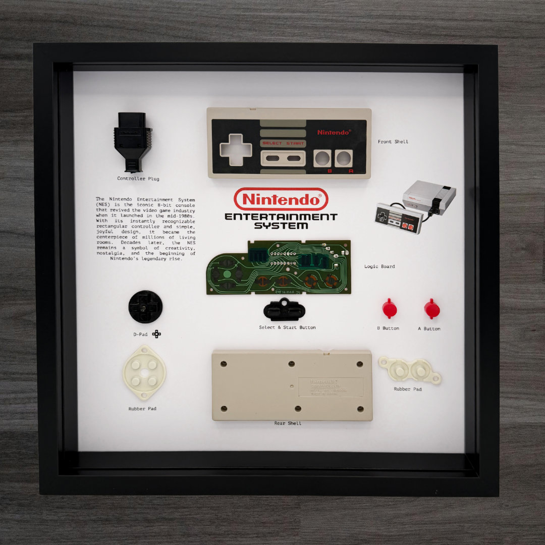 Framed display of Nintendo Entertainment System components on a wooden surface