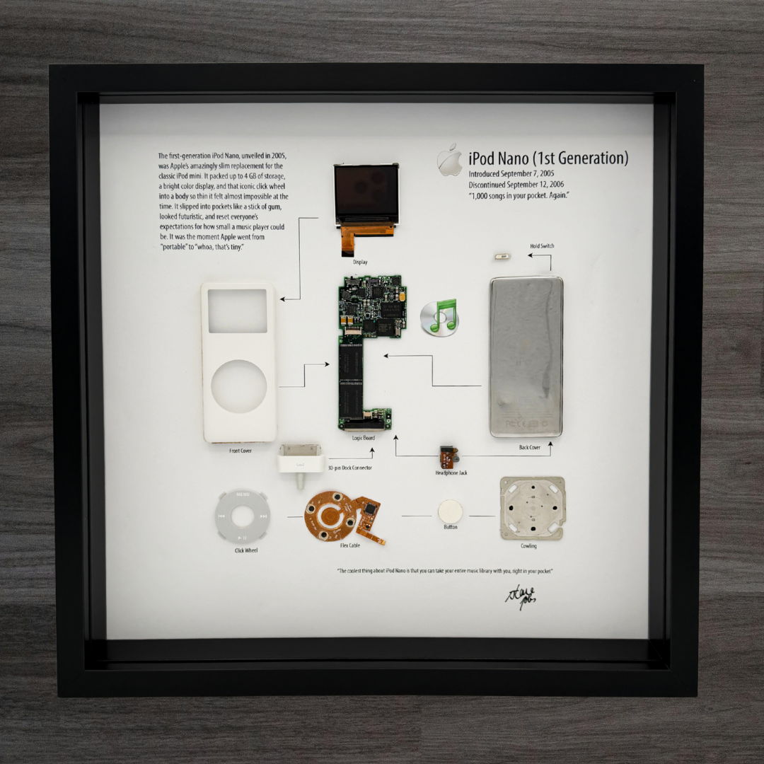 Framed display of an iPod Nano 1st generation with exploded view on a wooden surface