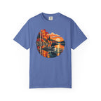 A blue short-sleeve crewneck t-shirt featuring a circular graphic print of a loon in a lake surrounded by colorful autumn trees and a sunset.