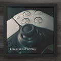 Close-up of a gaming controller with text 'A New Sense of Play' on a wooden surface.