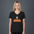A woman wearing a black graphic t-shirt with a white skeleton hand and orange text reading 'OFFICIAL SKELETON TESTER' on a gray studio background.