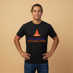 A man wearing a black t-shirt with a graphic of an orange witch hat and the text 'WITCH BETTER HAVE MY CANDY' in purple and orange, posed against a solid beige background.